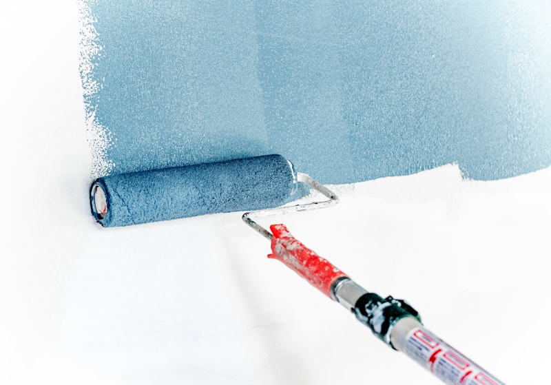 Professional painter applying fresh coat to interior wall in Slough home